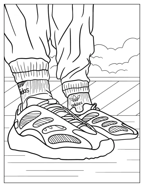 En man bär Yeezy Mono Safflower-skor och Adidas-strumpor.