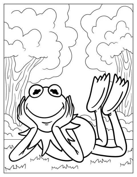 Kermit se relaxează întins pe iarbă.
