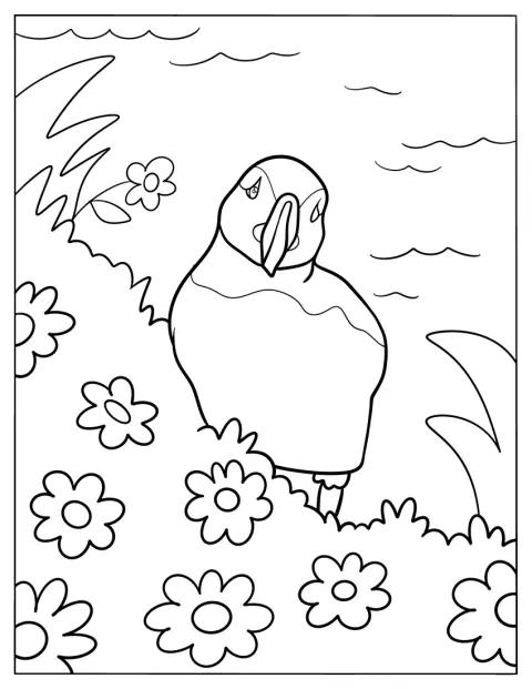 Un frailecillo está entre flores, junto al mar.