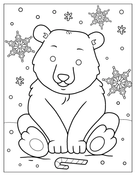 Un ourson polaire s’amuse dans la neige.