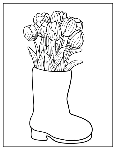 Mehrere Tulpen wachsen aus einem alten Stiefel.