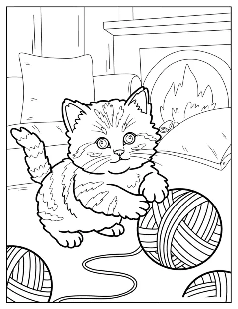 Pieni kissanpentu telmii suurten lankakerien kanssa.