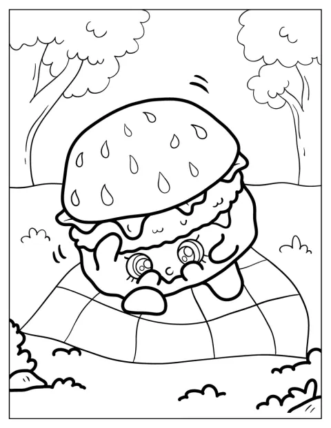 Een hamburger ligt op een kleed tijdens een picknick.