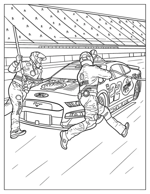 Une voiture NASCAR s’arrête aux stands pendant que l’équipe intervient.