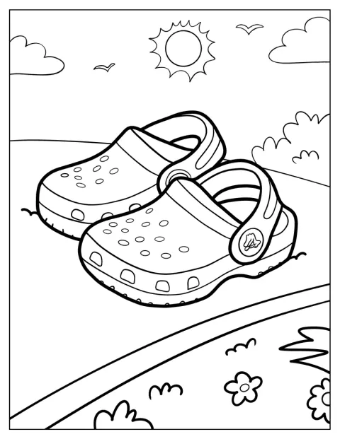 O pereche de Crocs mici stă sub un soare strălucitor.
